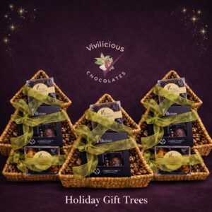 A modern color photograph of three tree-shaped boxes with chocolates inside. The background is purple and it has the Vivilicious logo at the top.
